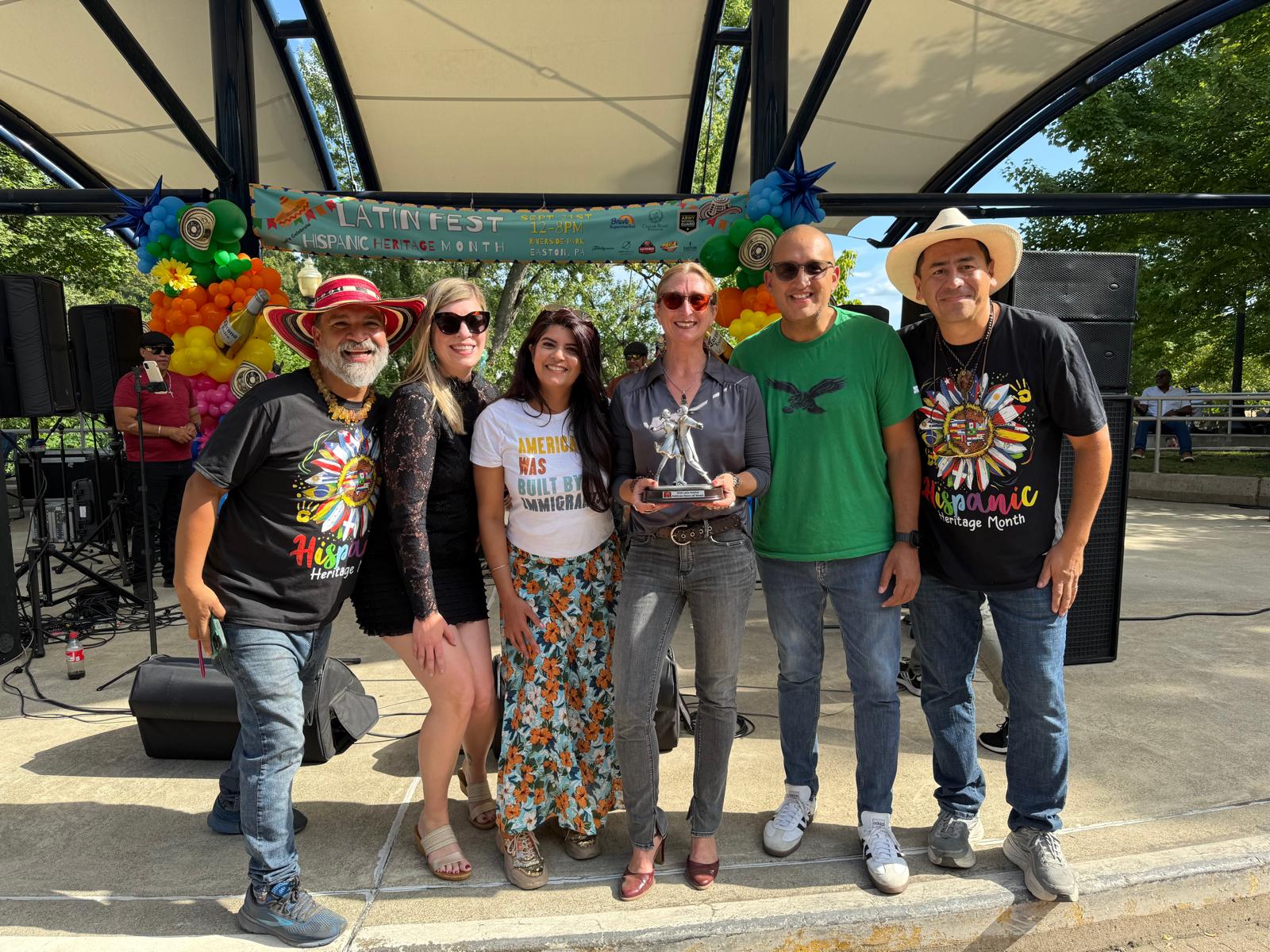 Community members celebrating an award on the festival stage
