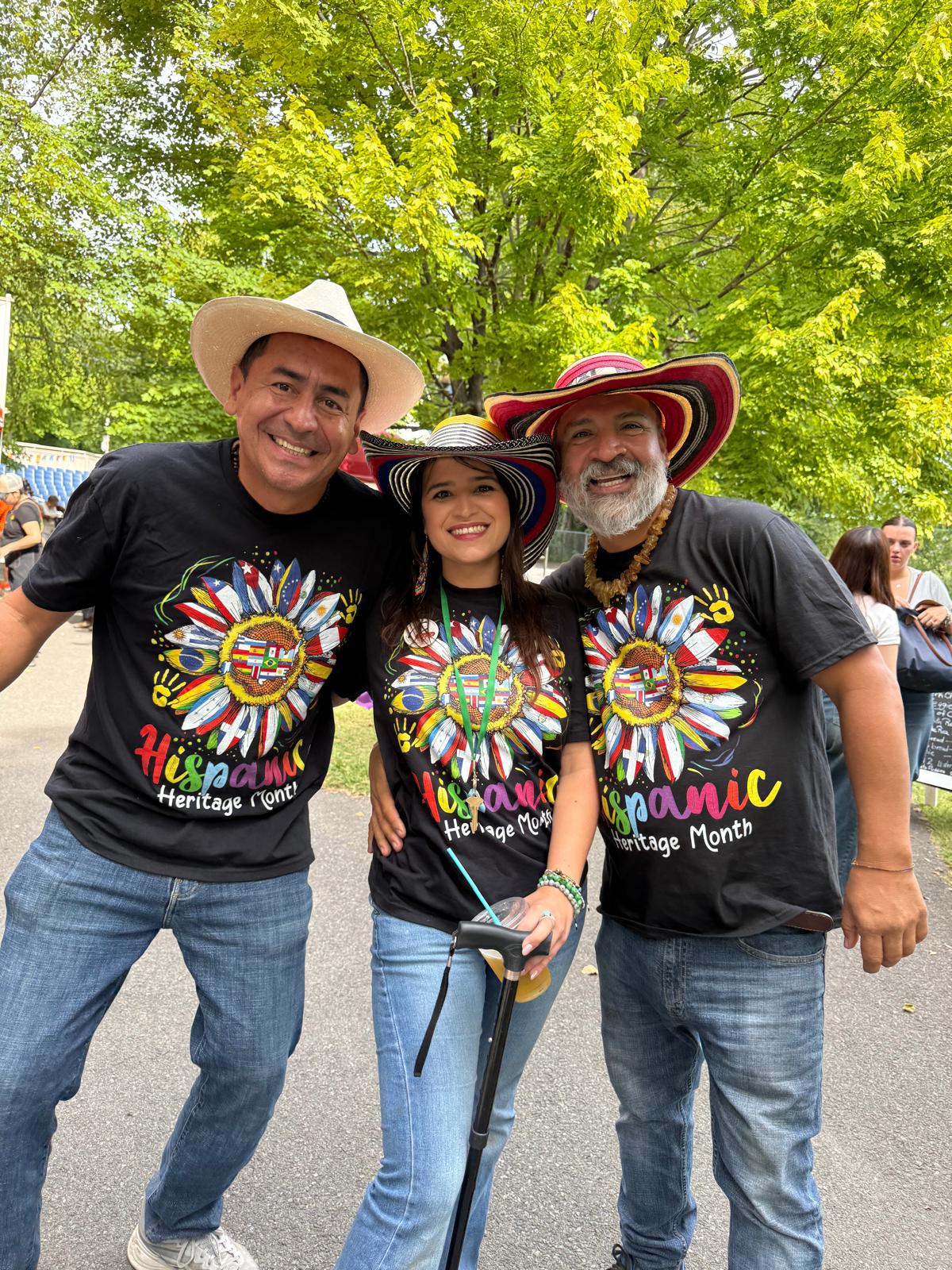 Festival organizers wearing cultural hats and matching shirts