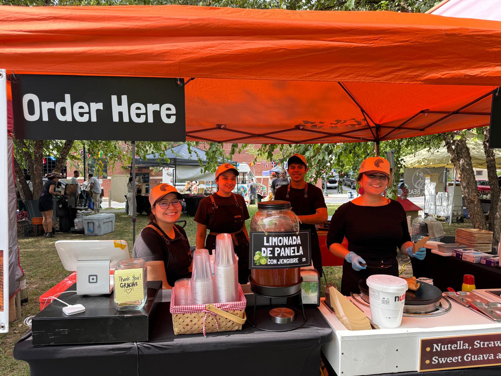 Food vendor team welcoming festival visitors