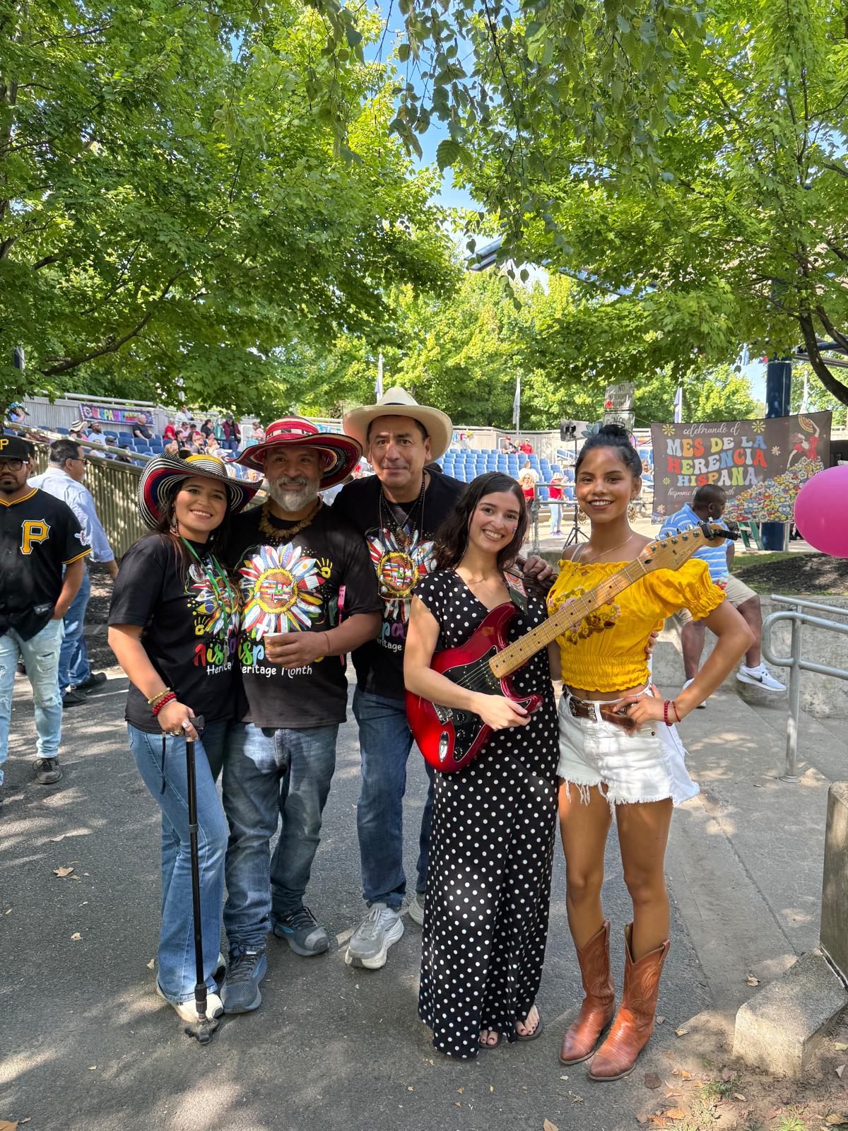 Musicians posing with festival organizers